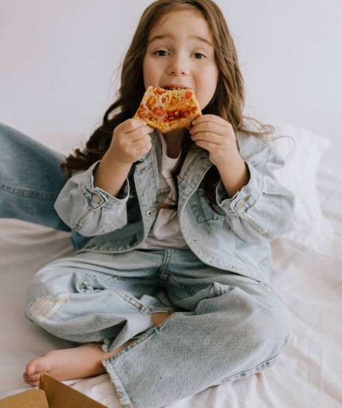 little 5 year old girl eating pizza margherita having lunch - junk food stock pictures, royalty-free photos & images