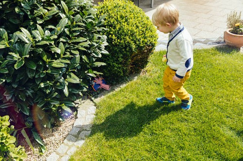 little boy finding an easter surprise in the garden - garden decoration stock pictures, royalty-free photos & images