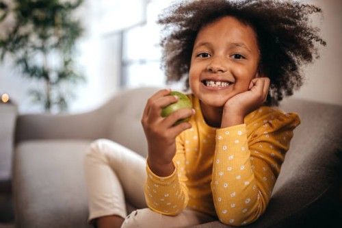 little girl eating apple at home - food stock pictures, royalty-free photos & images