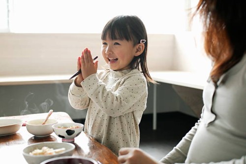 little girl eating meal,smiling - food stockfoto's en -beelden