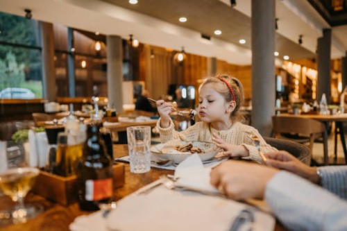 little girl eating pancake in restaurant - food stock pictures, royalty-free photos & images