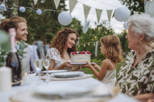 little girl handing the bride a wedding cake. - garden decoration stock pictures, royalty-free photos & images
