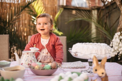 little girl smiling at the easter table - garden decoration stock pictures, royalty-free photos & images