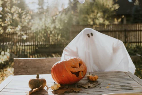 lonely ghost sitting on the porch during halloween - home decoration stock pictures, royalty-free photos & images