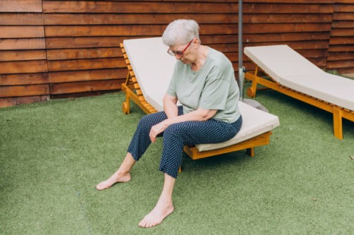 lonely sad senior woman sitting - garden decoration photos et images de collection