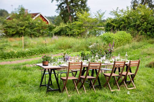 long outdoor dining table in lush swedish garden - garden decoration stock pictures, royalty-free photos & images
