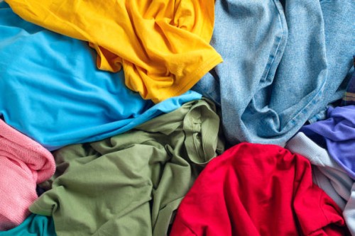 lots of bright dirty colorful scattered clothes, abstract background. the concept of homework, lack of time for household chores. - fashion stock pictures, royalty-free photos & images