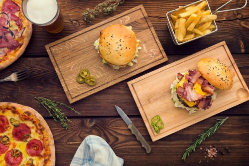 lots of food on table - junk food stock pictures, royalty-free photos & images