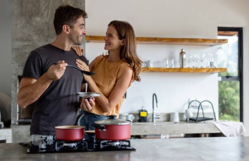 loving couple cooking dinner together - food stock pictures, royalty-free photos & images