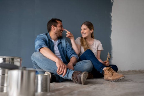 loving couple having fun painting their house and taking a break - home decoration stock pictures, royalty-free photos & images