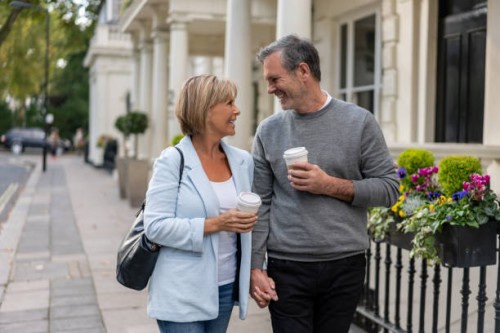 loving couple on the street having a cup of coffee to go - junk food stock pictures, royalty-free photos & images