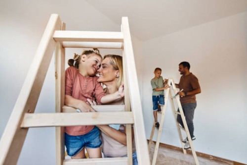 loving mother and daughter on ladders during home renovation process. - home decoration stock pictures, royalty-free photos & images