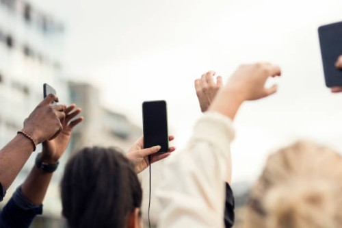 low angle view of friends holding smart phones - concert stock pictures, royalty-free photos & images