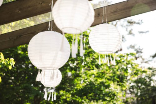 low angle view of white lanterns hanging from pergola at patio - garden decoration stock pictures, royalty-free photos & images