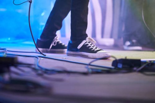 low section of a person's foot on a stage performance rock concert event - concert stock pictures, royalty-free photos & images
