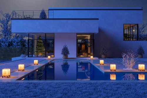luxury villa decorated with christmas tree, gift boxes and ornaments in snowy weather at night - garden decoration stock pictures, royalty-free photos & images