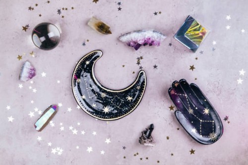 magic crystals for rituals. esoteric set with many tools on concrete gray background with silver and gold stars sequins. flat lay style - home decoration stockfoto's en -beelden