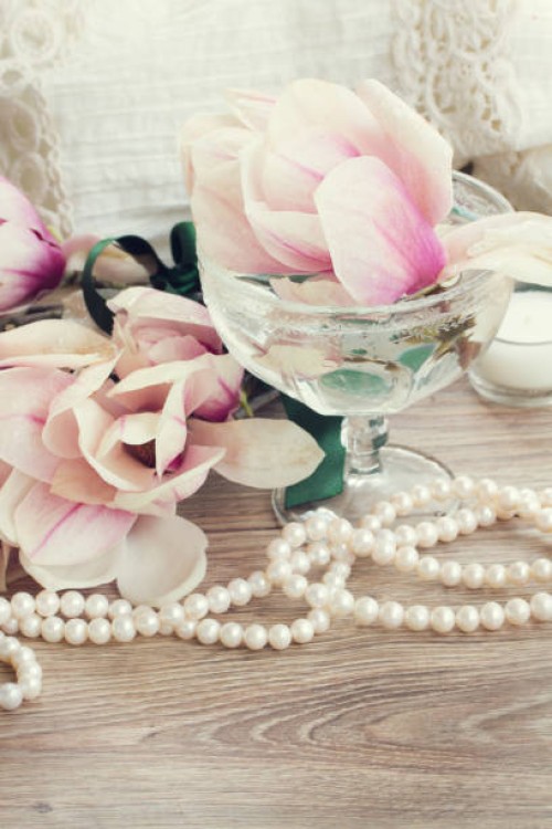 magnolia flowers with pearls on wooden table - garden decoration stock pictures, royalty-free photos & images
