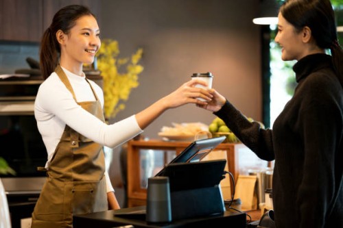 make me happy with drinks coffee. young asian women coffee shop owner serving black coffee to her customers in a cafe. service mind, point of sale system, and take-out foods. - junk food stock pictures, royalty-free photos & 