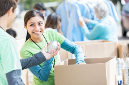 male and female volunteers sort donations during food drive - food stock pictures, royalty-free photos & images