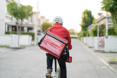 male delivery guy on bicycle with backpack in the city. - food stock pictures, royalty-free photos & images
