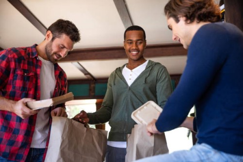 male friendship - having lunch at home together - junk food stock pictures, royalty-free photos & images
