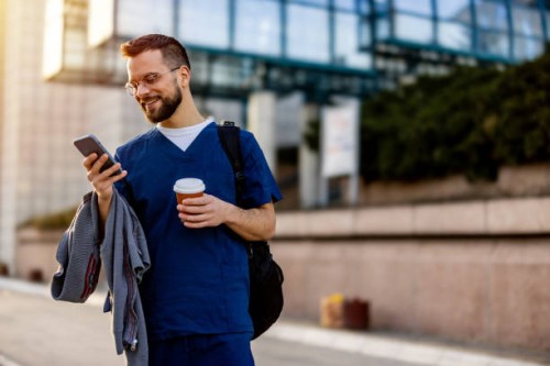 male nurse on the smartphone on the way to work - junk food stock pictures, royalty-free photos & images