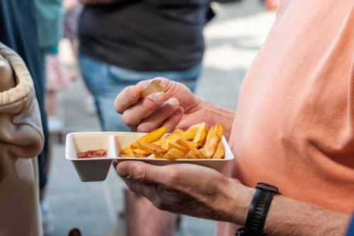 male person holding a fries tray - junk food stock pictures, royalty-free photos & images