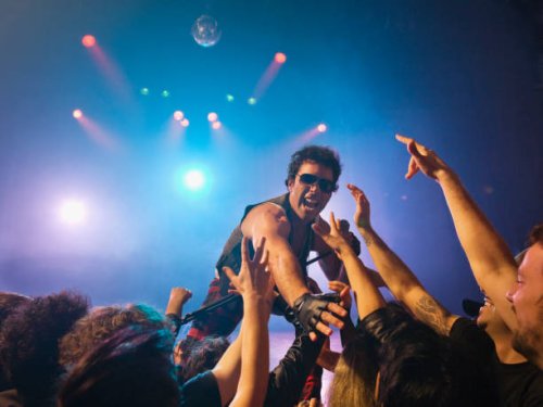 male rock star on stage interacting with audience - concert stock pictures, royalty-free photos & images
