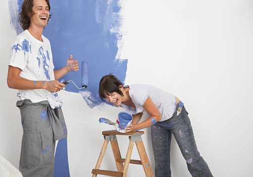 man and woman playing with paint - home decoration stock pictures, royalty-free photos & images