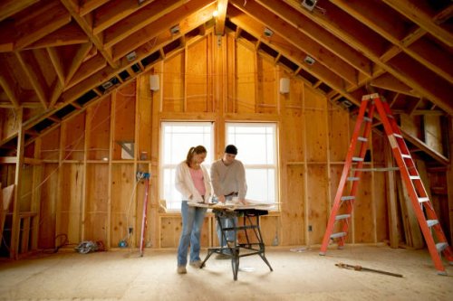 man and young woman looking at blueprints in house under construction - home decoration stock pictures, royalty-free photos & images