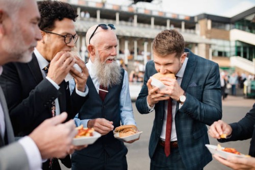 man biting into a burger - junk food stock pictures, royalty-free photos & images