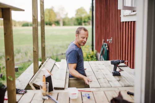 man building a patio outside his country side house - home decoration stock pictures, royalty-free photos & images
