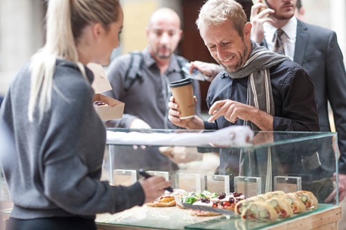 man buying food at city market - junk food stock pictures, royalty-free photos & images