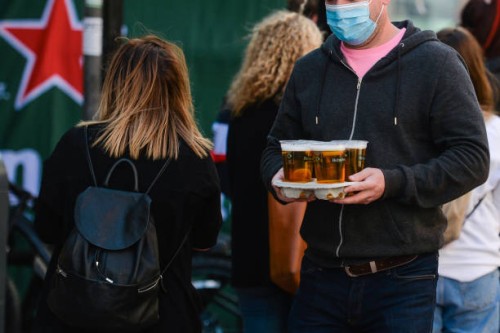 Man carries takeaway pints in Dublin city center, during the COVID-19 lockdown. On Saturday, 17 April 2021, in Dublin, Ireland.