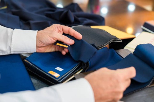 man checking fabric swatches - fashion stock pictures, royalty-free photos & images