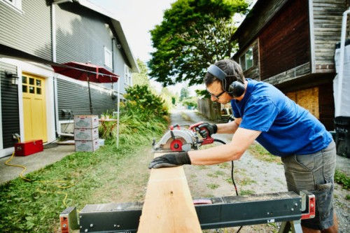 man cutting lumber for home improvement project - home decoration stock pictures, royalty-free photos & images