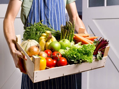 man delivering fruit and vegetable box. - food stockfoto's en -beelden