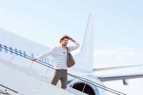 man disembarking a flight - fashion stock pictures, royalty-free photos & images