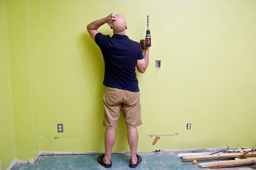 man doing home improvements with a power drill - home decoration stock pictures, royalty-free photos & images