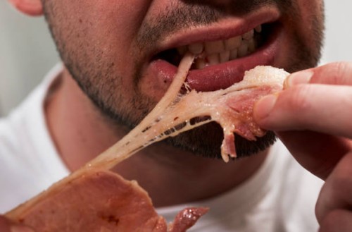 man eating bacon - junk food stock pictures, royalty-free photos & images