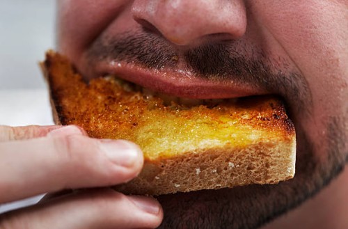 man eating bread - food fotografías e imágenes de stock