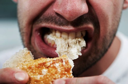 man eating bread - food photos et images de collection