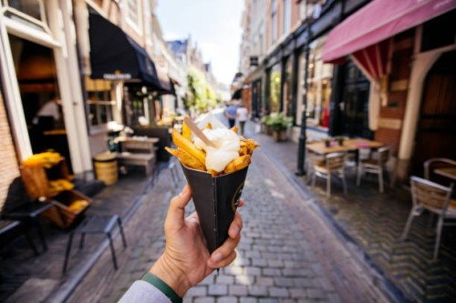 man eating french fries on the street, personal perspective - food stock pictures, royalty-free photos & images