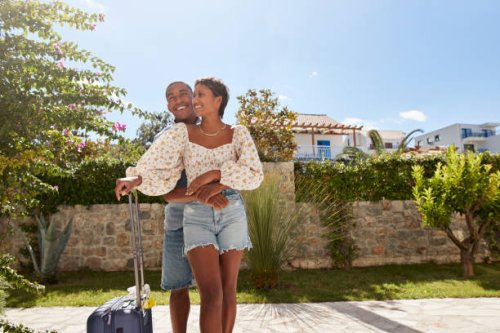 man embracing girlfriend in back yard on sunny day - travel stock pictures, royalty-free photos & images