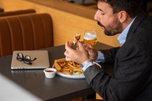 man finishing his burger - junk food stock pictures, royalty-free photos & images
