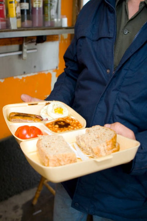 Man holding a takeaway all day breakfast in a polystyrene container on the 21st June 2008 in Victoria in the United Kingdom.