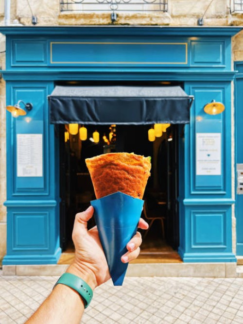 man holding crepe on the street in paris, france - junk food stock pictures, royalty-free photos & images