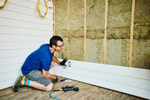 man installing siding during home improvement project - home decoration stock pictures, royalty-free photos & images