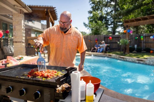man making mexican food while having a barbecue at home with his family - garden decoration stock pictures, royalty-free photos & images